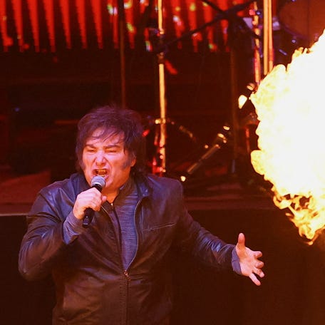 Argentine President Javier Milei sings with his band during the presentation of his book "Construction of the Miracle," at the Movistar Arena, in Buenos Aires, Argentina, on Oct. 6, 2025.