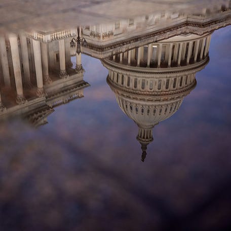 WASHINGTON, DC - OCTOBER 14: The Dome of the U.S. Capitol Building is visible in reflection on October 14, 2025 in Washington, DC. The government remains shut down after Congress failed to reach a funding deal 14 days ago. (Photo by Andrew Harnik/Getty Images)