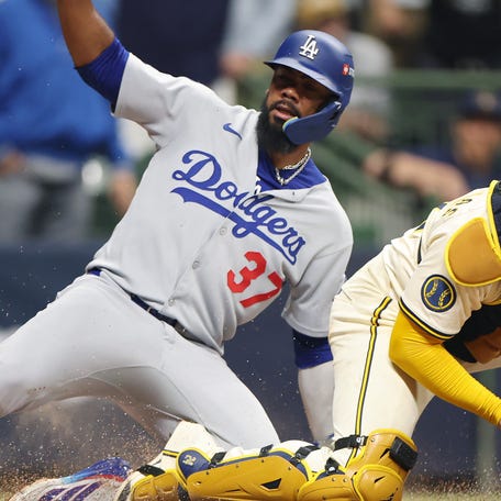 MILWAUKEE, WISCONSIN - OCTOBER 13: William Contreras #24 of the Milwaukee Brewers forces out at Teoscar HernÃ¡ndez #37 of the Los Angeles Dodgers at home plate during the fourth inning in game one of the National League Championship Series at American Family Field on October 13, 2025 in Milwaukee, Wisconsin. (Photo by Michael Reaves/Getty Images)