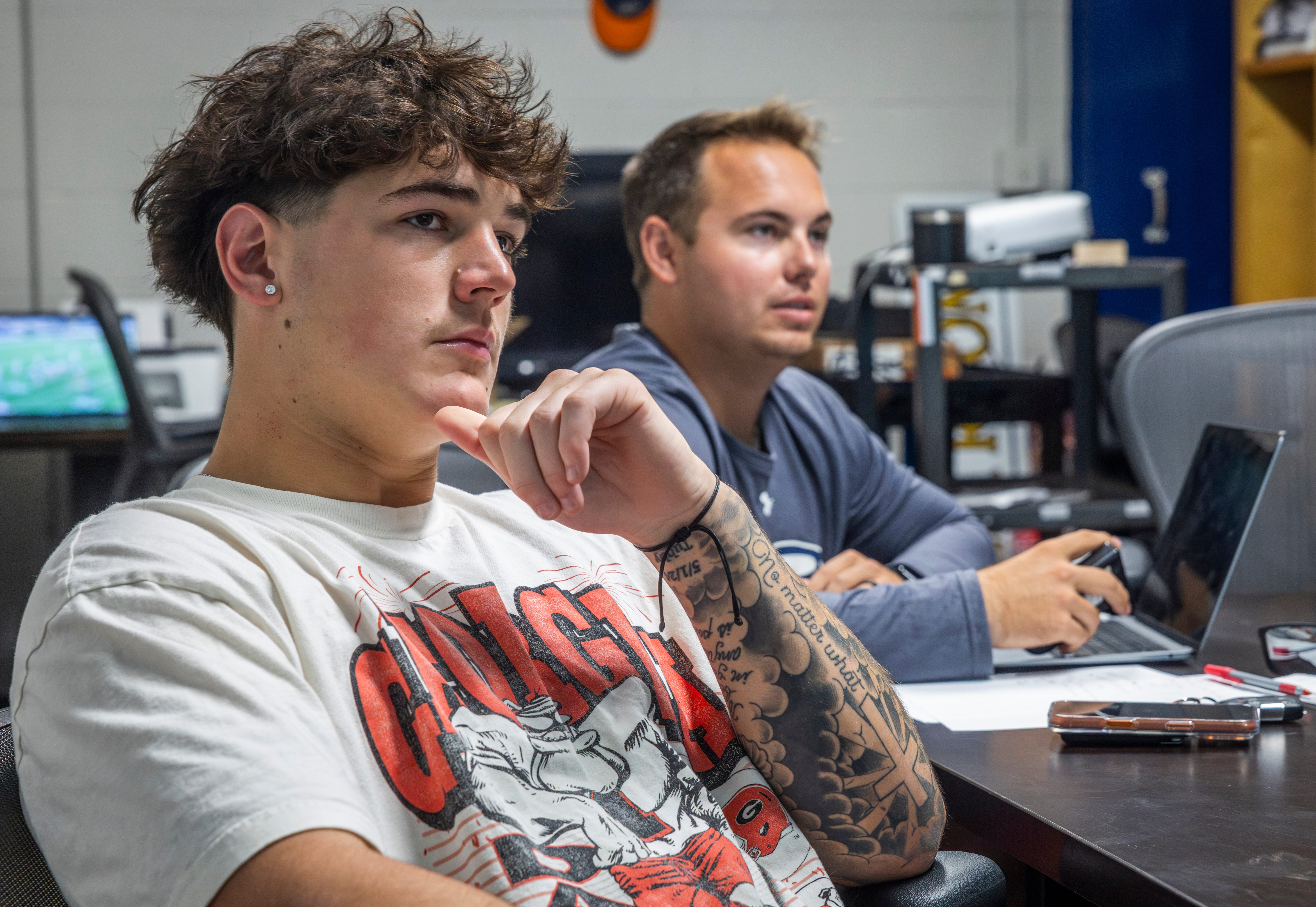 Nashville Christian quarterback Jared Curtis, left, reviews film with offensive coordinator Kyle Tidwell at the team’s locker room Tuesday, Oct. 14, 2025.