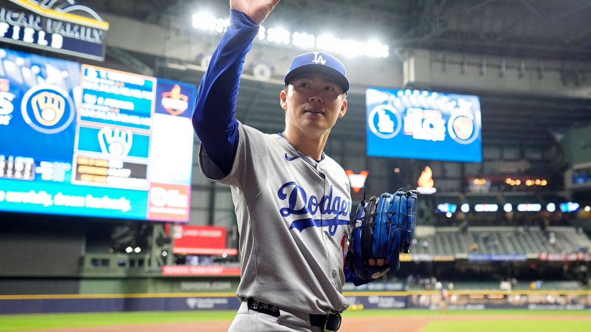 Yoshinobu Yamamoto waves to the crowd after his complete game.