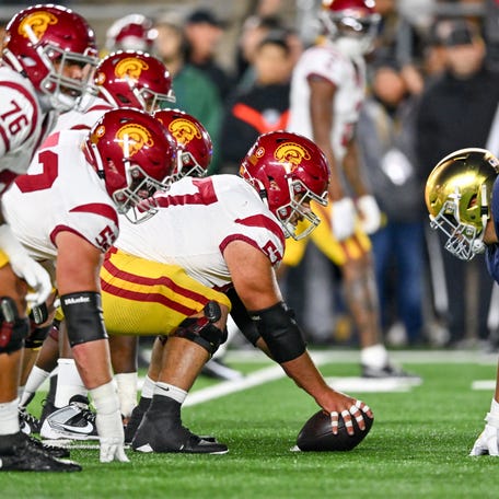 USC Trojans center Justin Dedich (57) prepares to snap as Notre Dame Fighting Irish defensive lineman Howard Cross III (56) defends in the second quarter at Notre Dame Stadium.