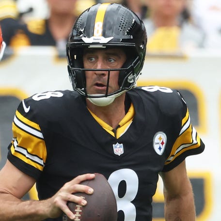 Oct 12, 2025; Pittsburgh, Pennsylvania, USA; Cleveland Browns defensive end Myles Garrett (95) and linebacker Carson Schwesinger (49) chase Pittsburgh Steelers quarterback Aaron Rodgers (8) during the second quarter at Acrisure Stadium. Mandatory Credit: Charles LeClaire-Imagn Images