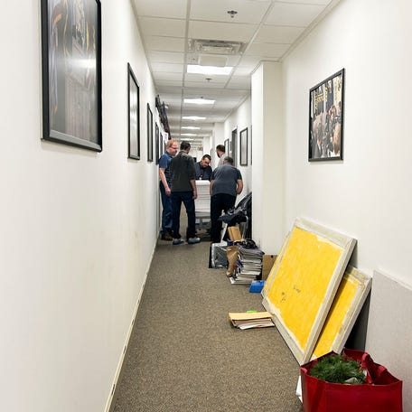 Members of a news media crew take down journalists' workspaces after at least 30 news organizations declined to sign a new Pentagon access policy for journalists, at the Pentagon in Washington, D.C., U.S., October 15, 2025.