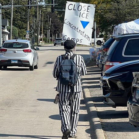 A protester wearing a replica concentration camp uniform departs the Immigration and Customs Enforcement facility in Broadview, Illinois, on Oct. 16, 2025.