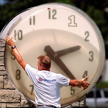 Updating a public clock in Riviera Beach, Florida, in 1999.