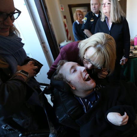 Sen. Maggie Hassan, D-New Hampshire speaks with her son, Ben as the family gets ready to vote at Newfields Town Hall with her husband, Tom on Tuesday, Nov. 8, 2022.