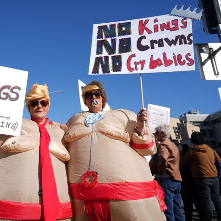 Angela Letney, left, and Michelle Bryant participate in the "No Kings" protest against the Trump administration at the Oregon State Capitol in Salem on Oct. 18.