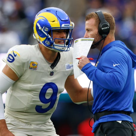 Oct 12, 2025; Baltimore, Maryland, USA; Los Angeles Rams quarterback Matthew Stafford (9) speaks with head coach Sean McVay during the second half of the game against the Baltimore Ravens at M&T Bank Stadium.