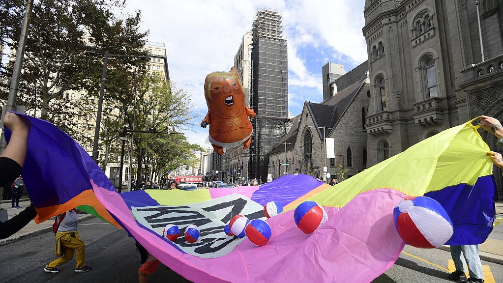 People participate in a "No Kings" national day of protest in Philadelphia, Pennsylvania, on October 18, 2025. From New York to San Francisco, millions of Americans are expected to hit the streets to voice their anger over President Donald Trump's policies at nationwide "No Kings" protests. (Photo by Matthew HATCHER / AFP) (Photo by MATTHEW HATCHER/AFP via Getty Images)