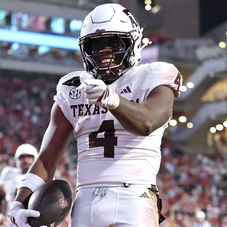 Texas A&M running back Rueben Owens II (4) celebrates after rushing for a touchdown in the fourth quarter against Arkansas at Donald W. Reynolds Razorback Stadium.