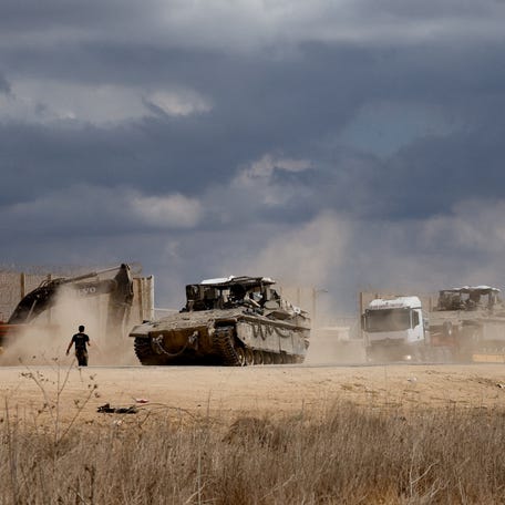 An Israeli soldier stands near military vehicles, amid a ceasefire between Israel and Hamas in Gaza, at the Israel-Gaza border in southern Israel October 12, 2025.