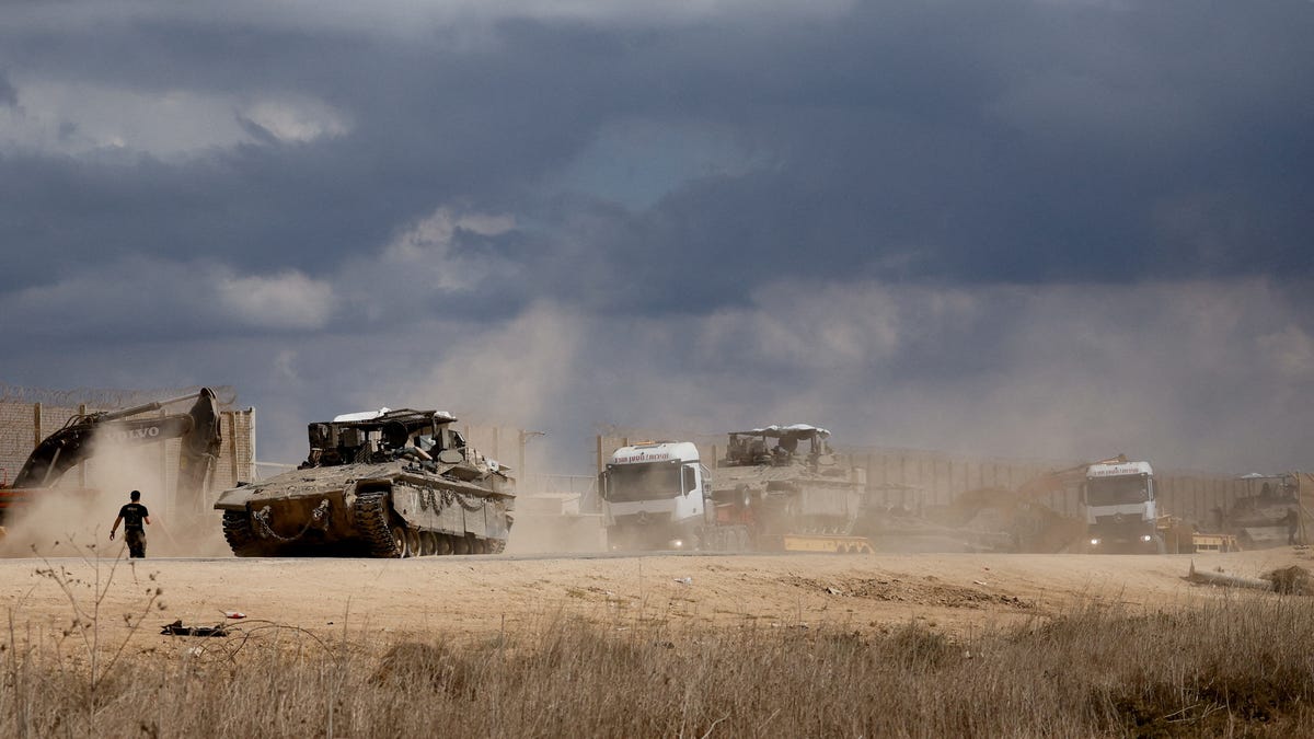 An Israeli soldier stands near military vehicles, amid a ceasefire between Israel and Hamas in Gaza, at the Israel-Gaza border in southern Israel October 12, 2025.