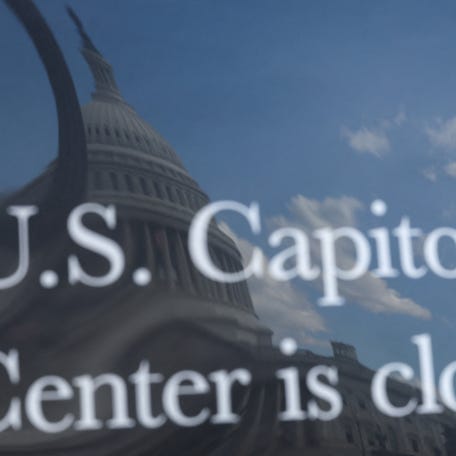 The U.S. Capitol building is reflected in a sign alerting visitors that the U.S. Capitol Visitor Center is closed, weeks into the continuing U.S. government shutdown in Washington, D.C. on Oct. 20, 2025.