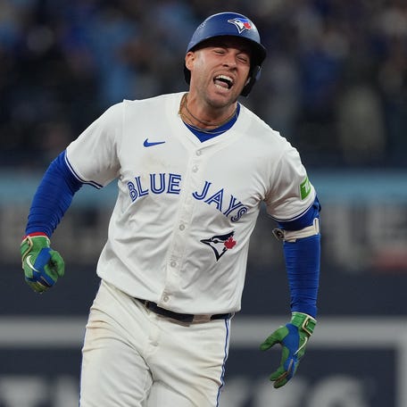 George Springer celebrates after hitting a three-run home run.