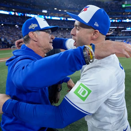 TORONTO, ONTARIO - OCTOBER 20: Don Mattingly #46 and George Springer #4 of the Toronto Blue Jays celebrate after defeating the Seattle Mariners in game seven of the American League Championship Series at the Rogers Centre on October 20, 2025 in Toronto, Ontario. (Photo by Mark Blinch/Getty Images)