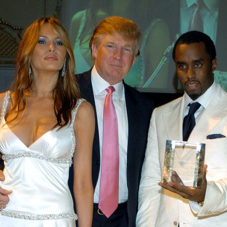Sean "Diddy" Combs, right, accepts an award from the Rush Philanthropic Foundation for his efforts to support public education and dedication to youth and social activism, from Donald Trump, center, and his wife Melania Trump at Trump's Mar-A-Lago Club in Palm Beach, Florida, on March 11, 2005.