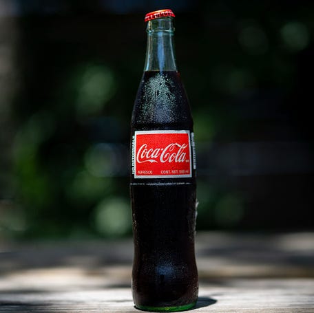 In this photo illustration, a bottle of Coca-Cola imported from Mexico is displayed on a table on July 17, 2025 in Austin, Texas. U.S. President Donald Trump stated in a Truth Social post that Coca-Cola has agreed to use real cane sugar in its U.S. beverages, similar to Mexican Coke.