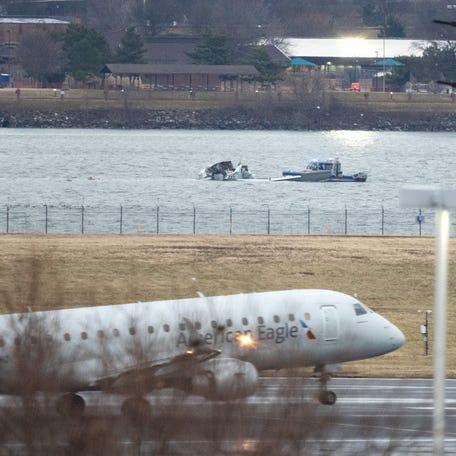 The wreckage of the American Airlines passenger jet is visible as flights land at Ronald Reagan Washington National Airport on Friday, Jan. 31, 2025, days after it collided with an Army Black Hawk helicopter, resulting in the deaths of 67 people.