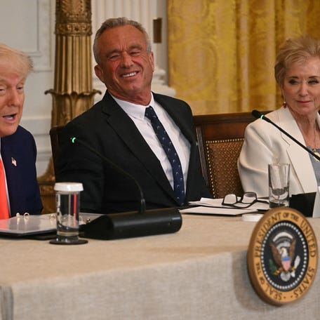 US President Donald Trump speaks as US Secretary of Health and Human Services Robert F. Kennedy Jr. (C), and US Secretary of Education Linda McMahon look on during a MAHA (Make America Healthy Again) Commission Event in the White House in Washington, DC, on May 22, 2025.