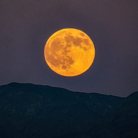 The Harvest moon rises Oct. 6 over the Little San Bernadino Mountains as seen after sunset from Palm Desert, California.