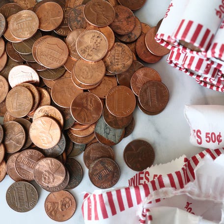 In this photo illustration, pennies are seen on a table on February 10, 2025 in New York City. President Donald Trump directed the Treasury Department to stop minting new pennies, citing the rising cost of producing the one-cent coin.