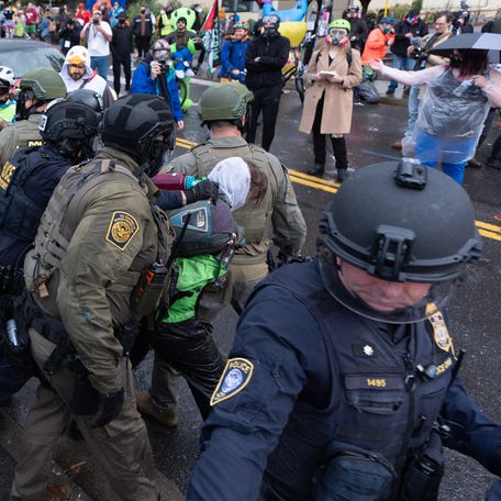 Immigration and Customs Enforcement officers class with protesters in front of their facility in Portland, Oregon, on Oct. 12, 2025.