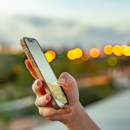 Madrid, Spain. iPhone against urban lights at twilight