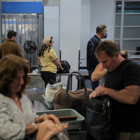 Travelers pass through a Transportation Security Administration (TSA) security screening at Hollywood Burbank Airport during the first day of a partial U.S. government shutdown in Burbank, California, U.S., October 1, 2025.