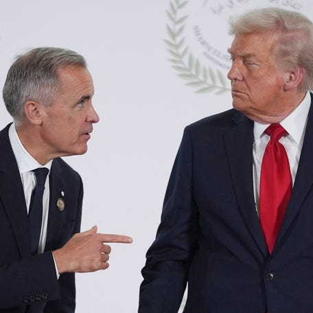 President Donald Trump greets Canada's Prime Minister Mark Carney during a summit on Gaza in Sharm el-Sheikh on October 13, 2025.