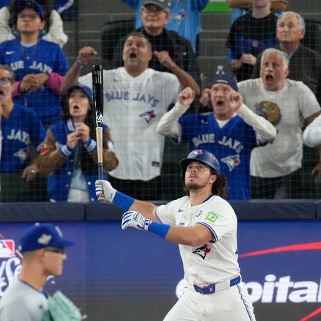 Oct 24, 2025; Toronto, Ontario, CAN; Toronto Blue Jays right fielder Addison Barger (47) hits a grand slam against the Los Angeles Dodgers in the sixth inning during game one of the 2025 MLB World Series at Rogers Centre. Mandatory Credit: Kevin Sousa-Imagn Images