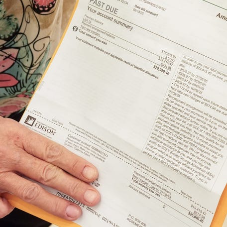 Tuesday Adams of Cathedral City shows her $20,000 SCE bill in Desert Hot Springs, Calif., June 25, 2025.