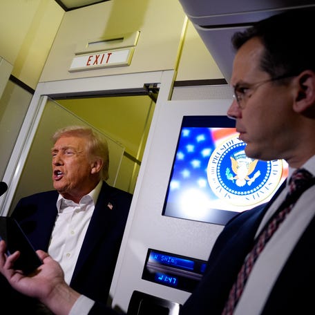 U.S. President Donald Trump speaks to members of the media aboard Air Force One on October 24, 2025, in flight.