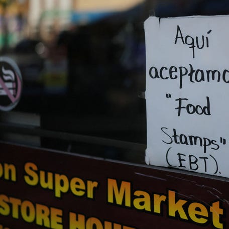 A handwritten sign advertises that "Food Stamps (EBT)" are accepted at a convenience store in Chelsea, Massachusetts, on Oct. 24, 2025.