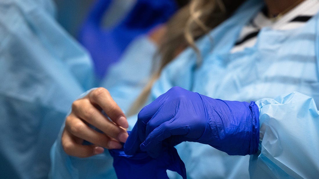 Mosley students put on personal protective equipment while visiting a trauma room at Ascension Sacred Heart Hospital in Panama City, Fla., March 28, 2025. (Tyler Orsburn/News Herald)