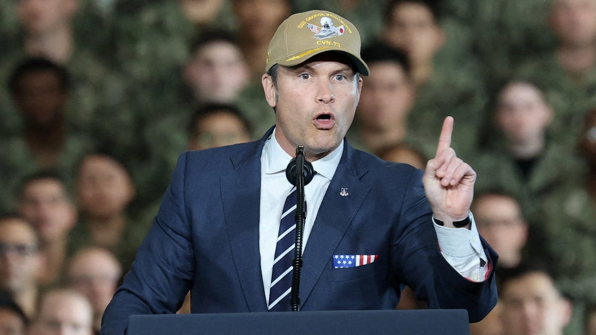 U.S. Secretary of Defense Pete Hegseth gestures as he speaks aboard the aircraft carrier USS George Washington, on the day of U.S. President Donald Trump's visit to the U.S. Navy's Yokosuka base in Yokosuka, Japan, October 28, 2025.