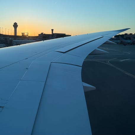 A watch tower stands in the distance of an American Airlines aircraft wing at Chicago's O'Hare International Airport on Oct. 8, 2025.
