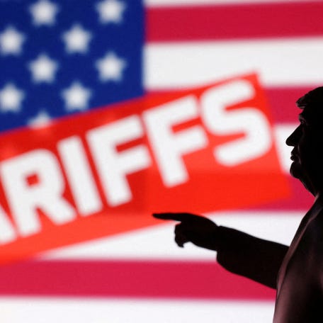 A 3D-printed miniature model of President Donald Trump with U.S. flag and word "Tariffs" in this illustration created on April 17, 2025.