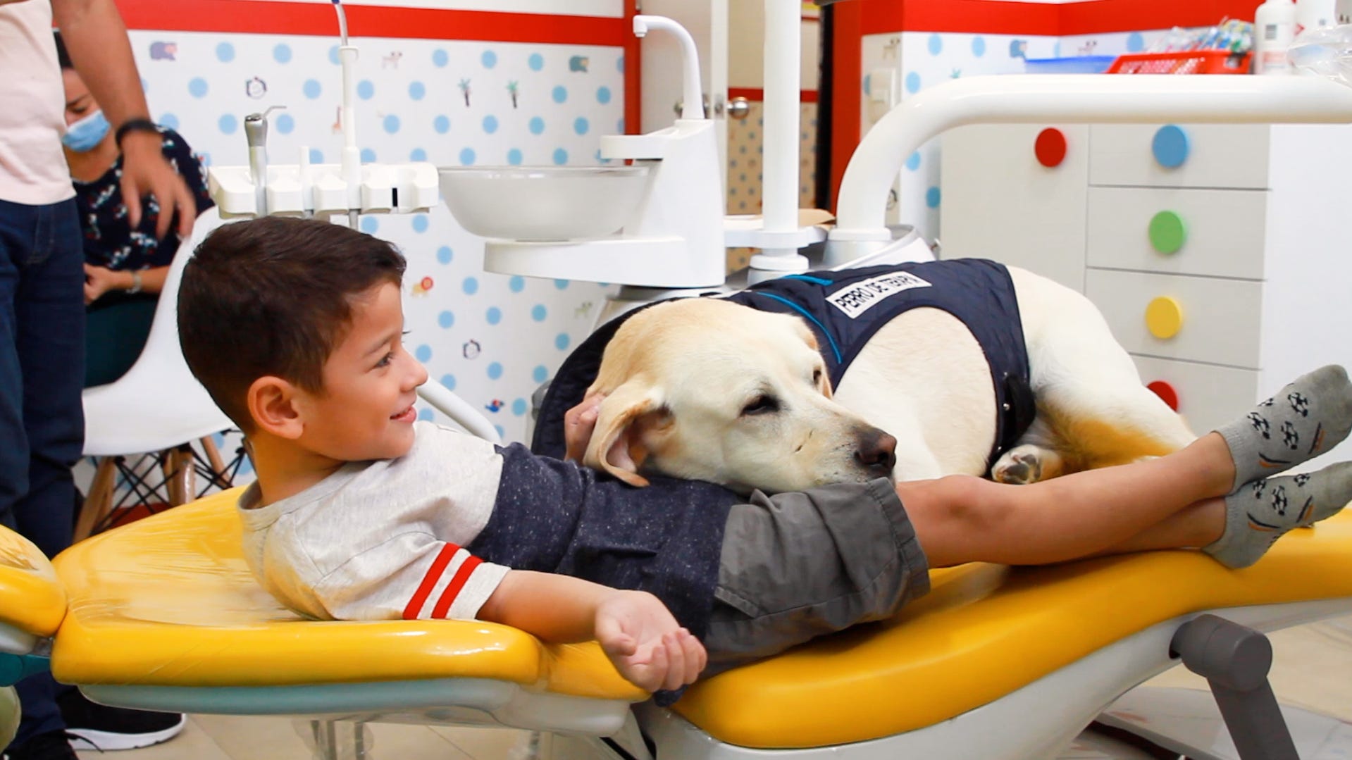 Dog comforts kids at the dentist office