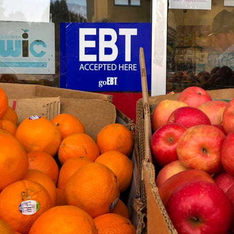 A sign noting the acceptance of electronic benefit transfer (EBT) cards that are used by state welfare departments to issue benefits is displayed at a grocery store on December 04, 2019 in Oakland, California.