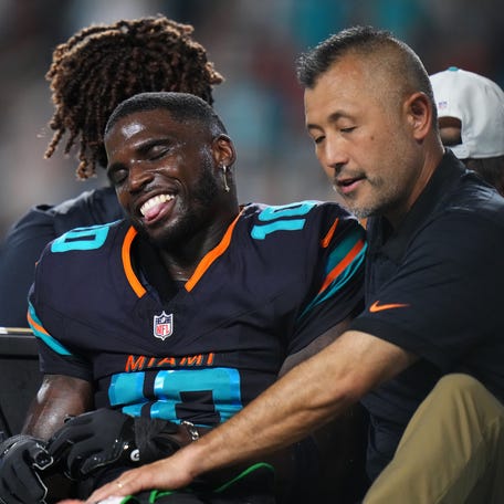 Sep 29, 2025; Miami Gardens, Florida, USA; Miami Dolphins wide receiver Tyreek Hill (10) is tended to by medical staff after injuring his leg against the New York Jets during the second half at Hard Rock Stadium.