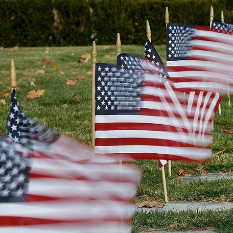 Veterans graves marked with U.S. flags at Mount Wollaston Cemetery in Quincy, Massachusetts on November 11, 2024
