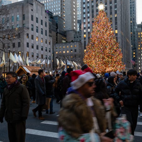 People walk through Rockefeller Center two days before Christmas in midtown Manhattan on December 23, 2024 in New York City.