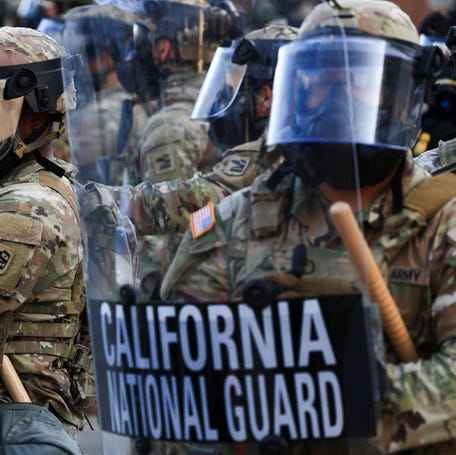 National Guard troops wear gas masks during protests against federal immigration sweeps in Los Angeles on June 12, 2025.