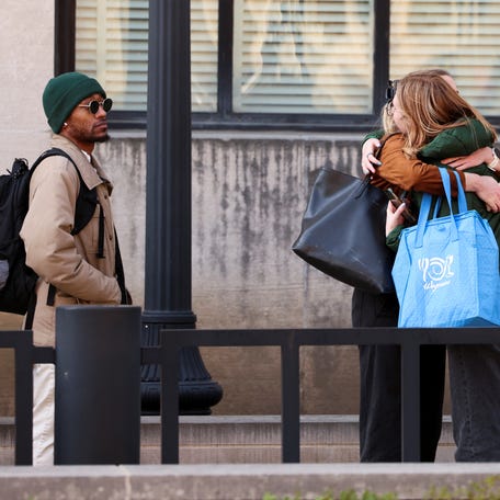 Employees of the Department of Health and Human Services (HHS) hug each other as they queue outside the Mary E. Switzer Memorial Building, after it was reported that the Trump administration fired staff at the Centers for Disease Control and Prevention and at the Food and Drug Administration, as it embarked on its plan to cut 10,000 jobs at HHS, in Washington, D.C., U.S., April 1, 2025. REUTERS/Kevin Lamarque