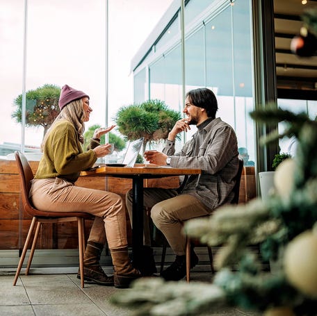 Young couple doing freelance work in cafe
