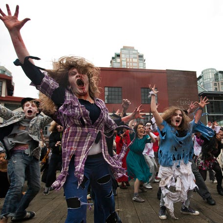 People dressed as Zombies dance to Michael Jackson's "Thriller" in downtown Vancouver, British Columbia October 23, 2010.