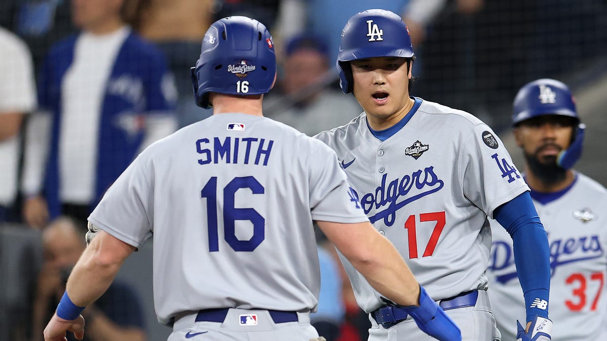 TORONTO, ONTARIO - OCTOBER 31: Shohei Ohtani #17 and Will Smith #16 of the Los Angeles Dodgers celebrate after scoring runs against the Toronto Blue Jays during the third inning in game six of the 2025 World Series at Rogers Center on October 31, 2025 in Toronto, Ontario. (Photo by Emilee Chinn/Getty Images)