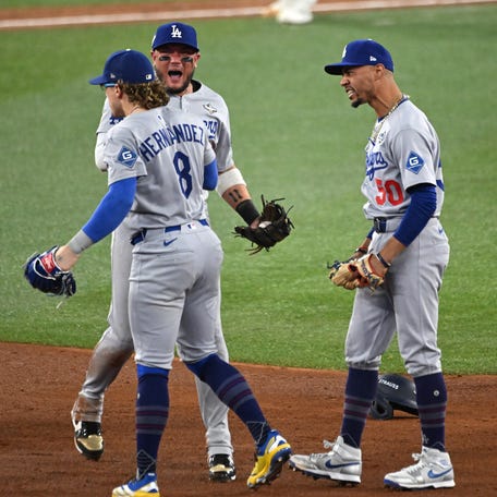 Los Angeles Dodgers outfielder Enrique Hernandez (8), second baseman Miguel Rojas (72) and shortstop Mookie Betts (50) celebrate after defeating the Toronto Blue Jays in Game 6 of the 2025 MLB World Series at Rogers Centre in Toronto, Ontario, Canada on Oct. 31, 2025.
