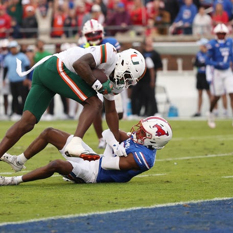 Miami wide receiver Joshisa Trader catches a pass against SMU defensive back Marcellus Barnes Jr. during the first quarter at Gerald J. Ford Stadium.